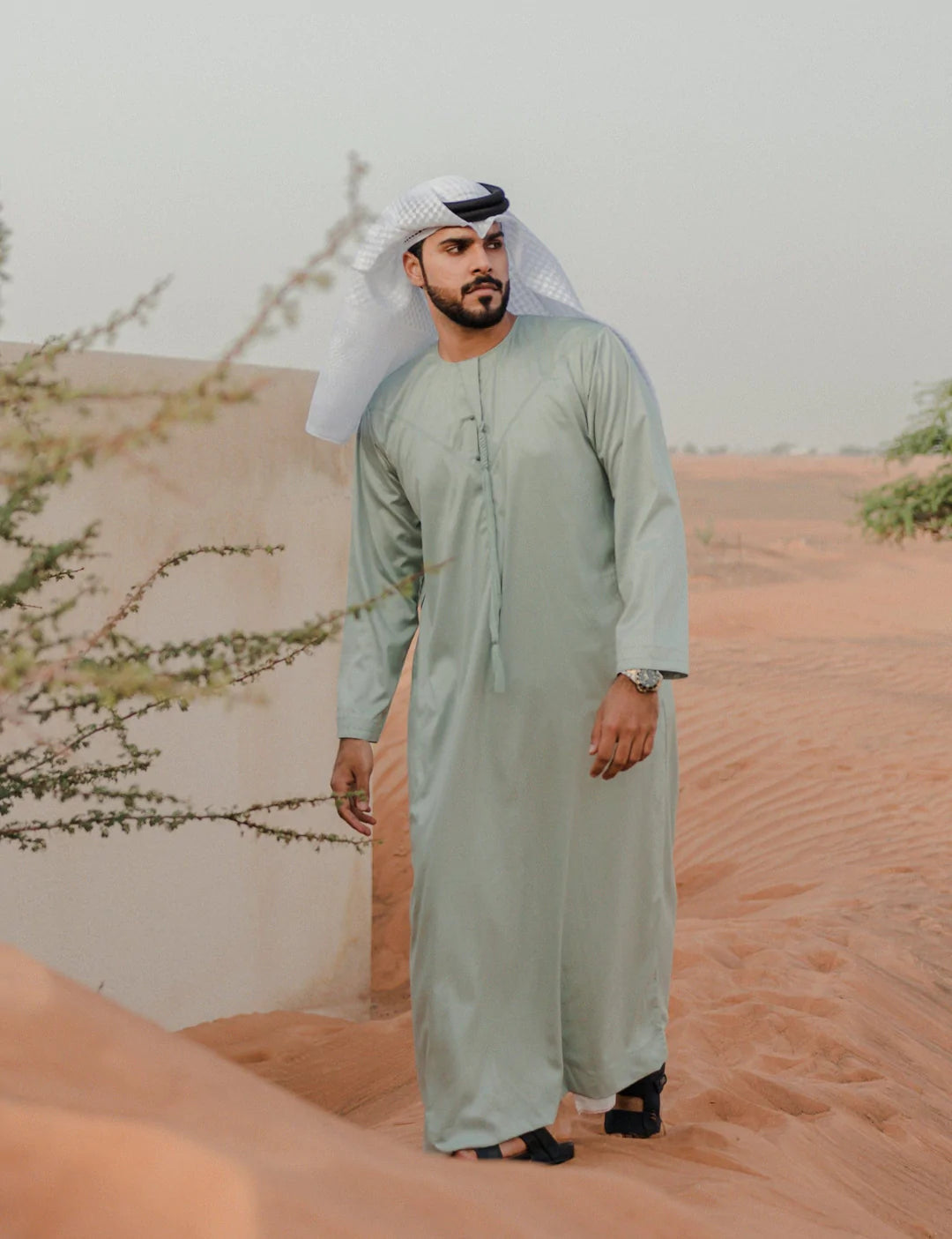 a man standing next to a woman on a beach 