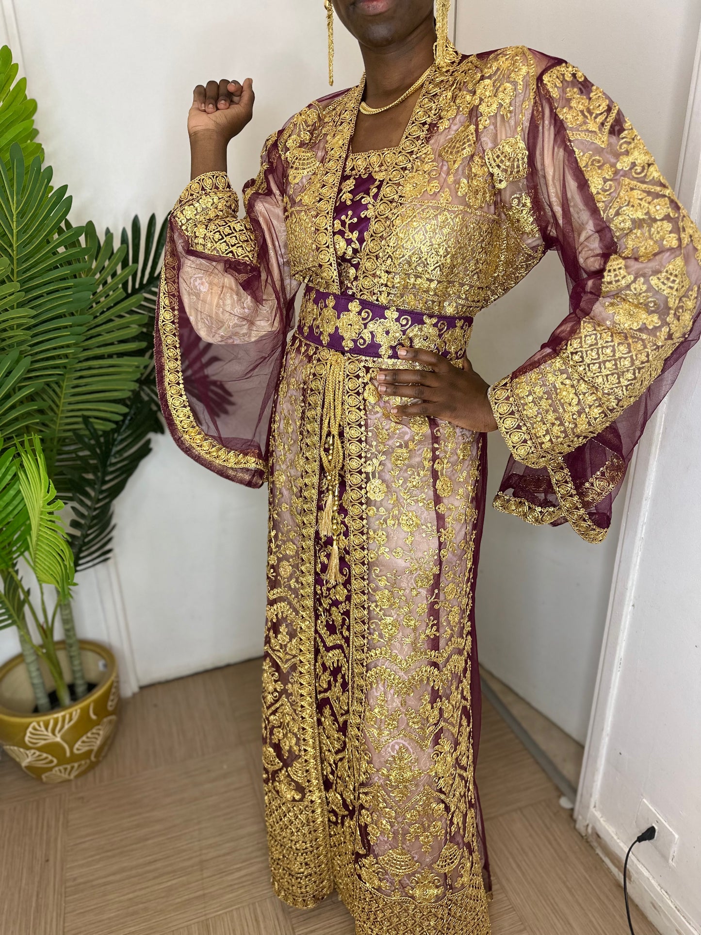 a woman dressed in a costume standing next to a vase 