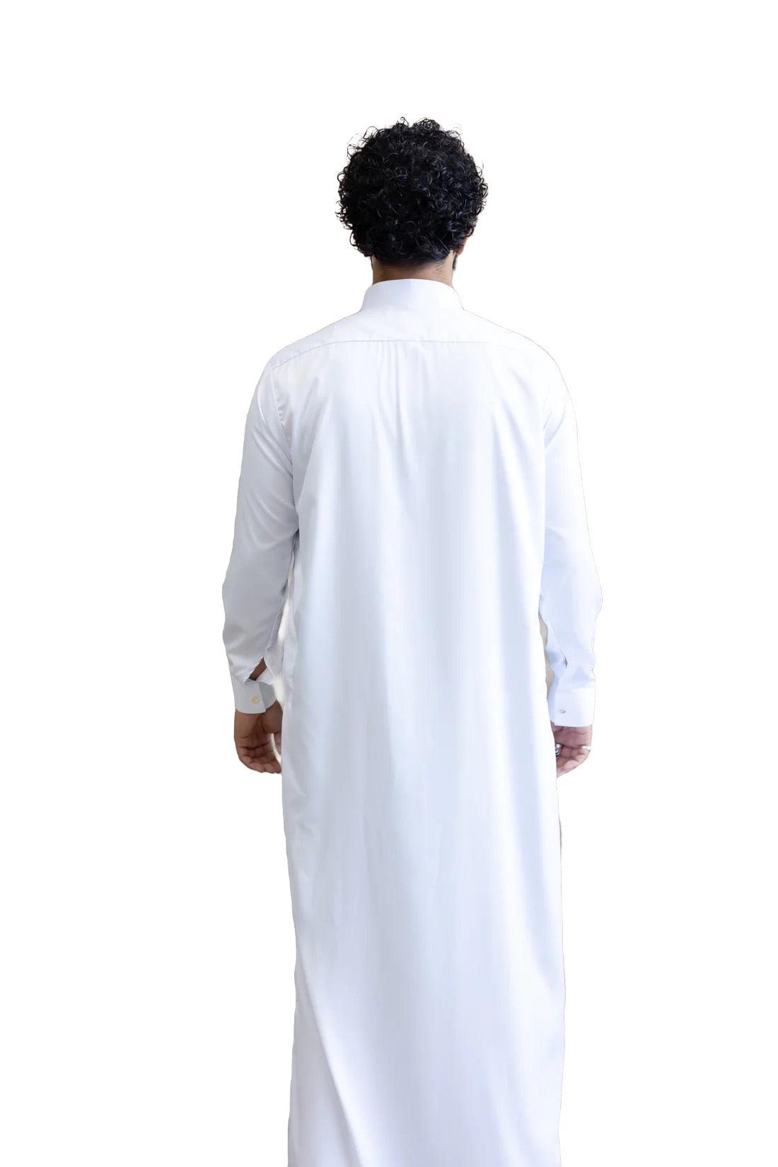 a man in a white shirt standing in a white dress 